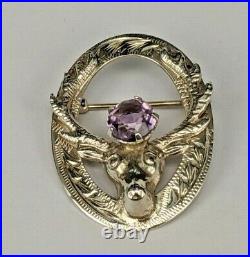 # A Scottish sterling silver stagshead brooch pin set with amethyst