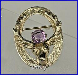 # A Scottish sterling silver stagshead brooch pin set with amethyst